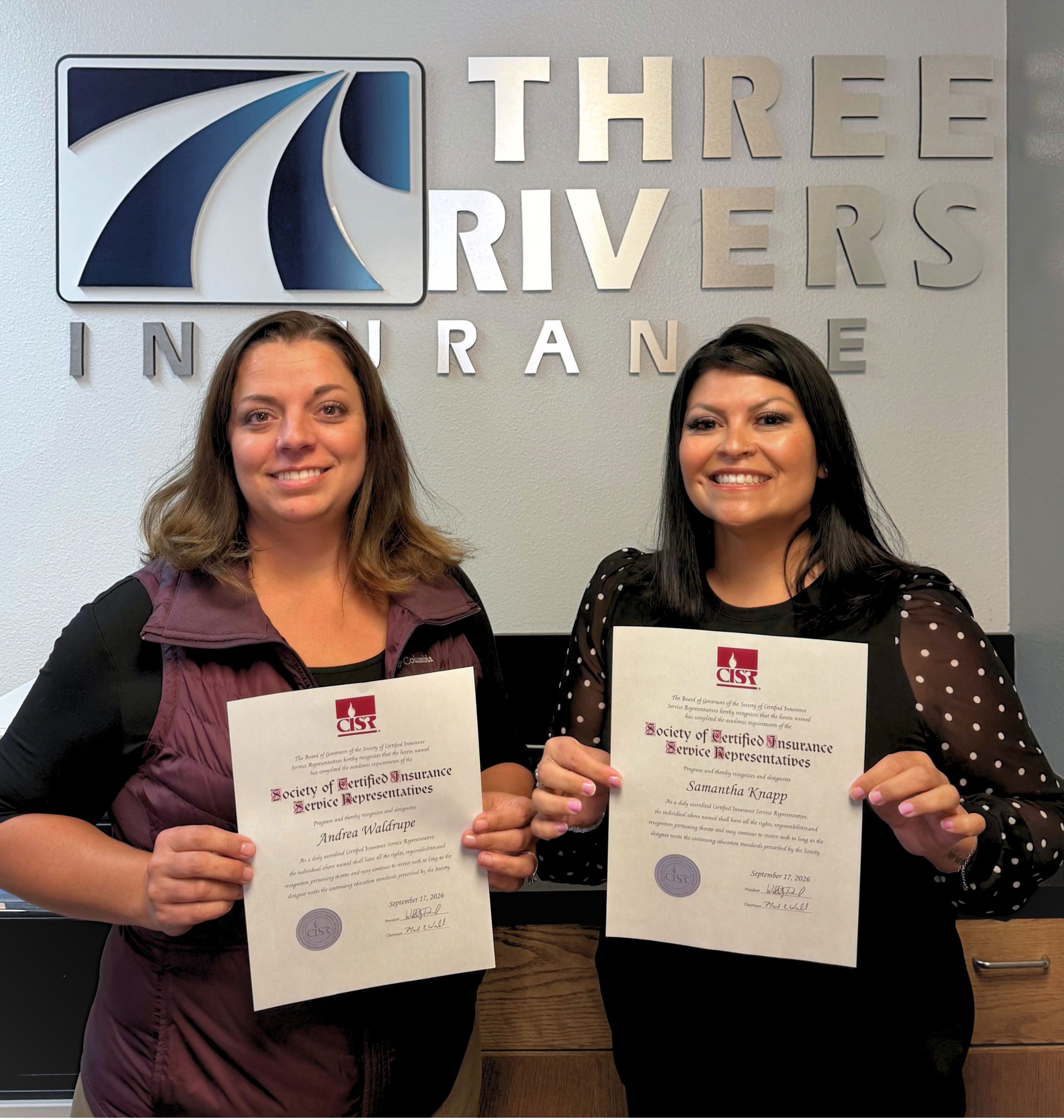 Personal Lines Agents, Jill Waldrupe and Samantha Knapp holding their recently earned CISR Designations.